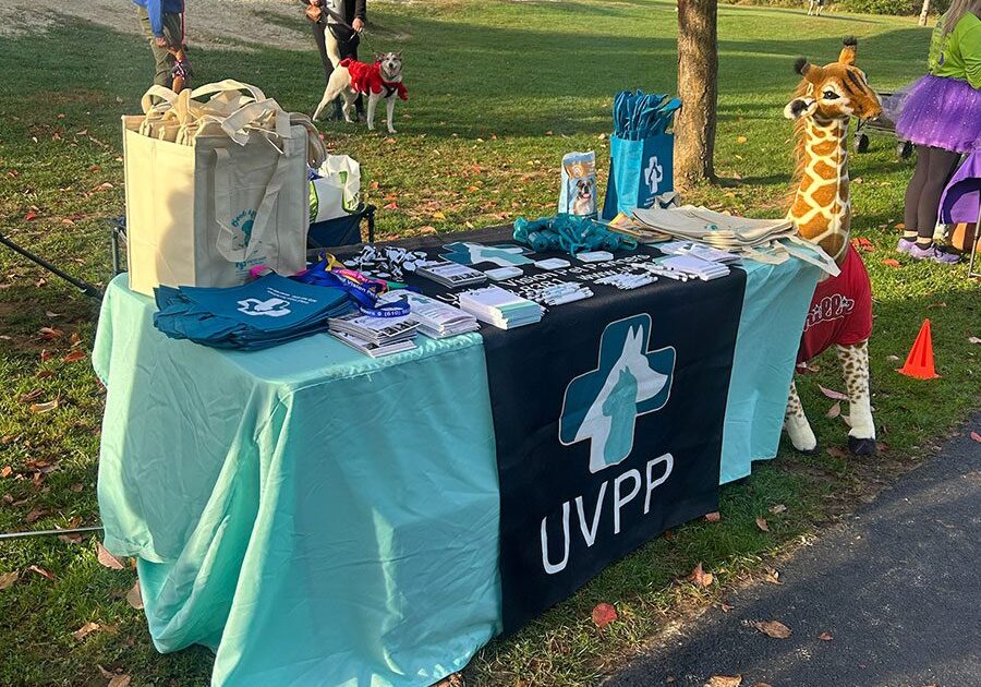 UVPP branded table booth with various swag at Miles for Mutts fundraiser 2025